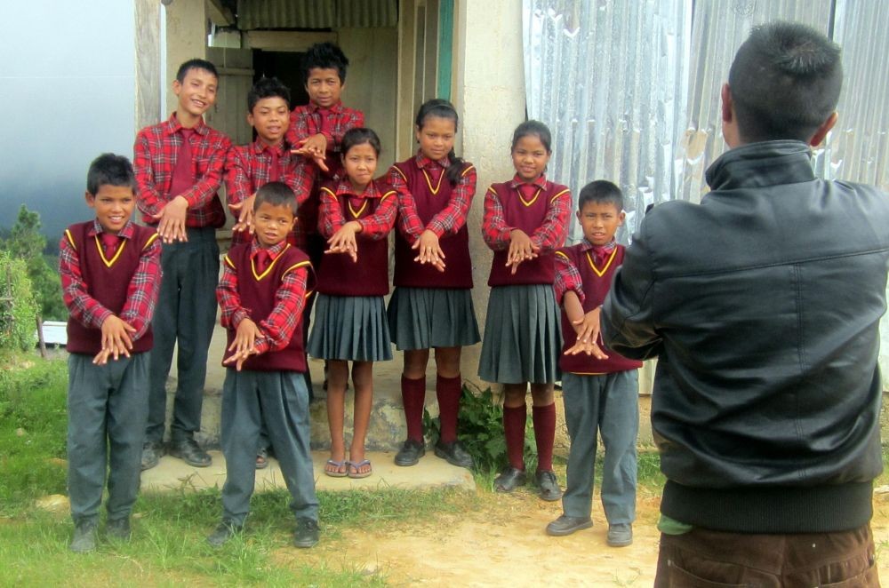 A Sarva Shiksha Abhiyan (SSA) staff gives a demonstration on hand-washing to students as a part of Intensified Diarrhoea Control Fortnight (IDCF) - 2014 campaign in Shillong on Aug 13, 2014. (Photo: IANS)